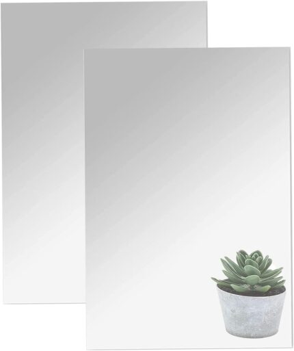 Two rectangular 16x12 inch DARENYI acrylic mirror sheets with adhesive backing, reflecting a room interior.