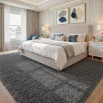 An 8x10 rectangular Fuzziness grey fluffy shag area rug with a modern tie-dye pattern on a living room floor.