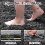 An 8x10 rectangular Fuzziness grey fluffy shag area rug with a modern tie-dye pattern on a living room floor.
