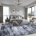A black 5x7 modern abstract area rug with subtle patterns, laid out in a living room setting.