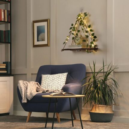 A set of two JOPSTDI White Flower floating triangle shelves with artificial ivy and LED lights, mounted on a wall.