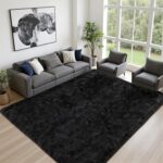 A black 8x10 Luxturiy fluffy shag area rug, shown spread out on a floor in a modern living room setting.