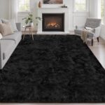 A luxurious black fluffy shag area rug, 5x7 feet, with a thick, soft pile, perfect for a living room or bedroom.