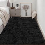 A luxurious black fluffy shag area rug, 5x7 feet, with a thick, soft pile, perfect for a living room or bedroom.