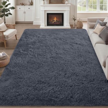 A soft, plush grey 8x10 shag area rug from Luxturiy, laid out in a modern living room setting.