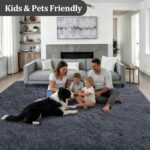 A soft, plush grey 8x10 shag area rug from Luxturiy, laid out in a modern living room setting.