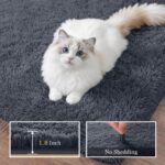 A soft, plush grey 8x10 shag area rug from Luxturiy, laid out in a modern living room setting.