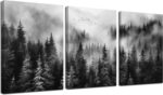 Three vertical panels of TYTAUPT black and white foggy forest canvas art, each 12x16 inches, hanging on a wall
